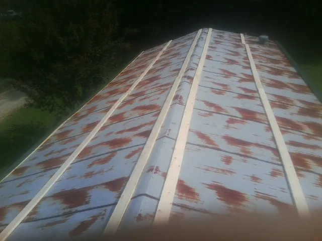 Rusted metal roof panels with new wood purlins before replacement — Storm Damage Roof Repair in Nelson by Roofing Brothers